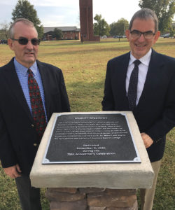 Two of Dr. J.T. Midkiff's sons Paul (left) and Phillip (right) stand with the new Midkiff Meadows dedication monument.